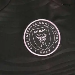 a black shirt with a pink circle and text
