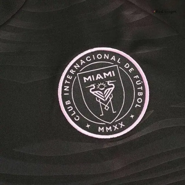 a black shirt with a pink circle and text