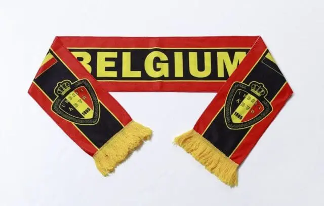 a red and black scarf with yellow tassels