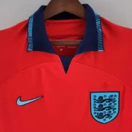 a red shirt with a blue and black logo