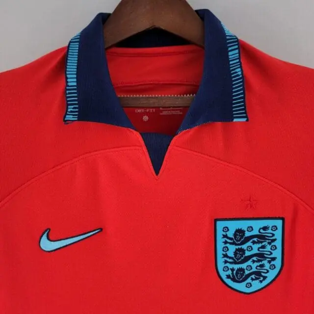 a red shirt with a blue and black logo
