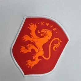 a red and orange emblem with a lion