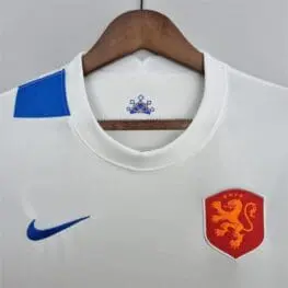 a white shirt with a lion emblem on it