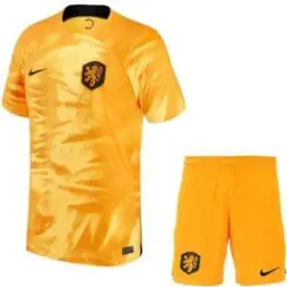 a yellow football uniform and shorts