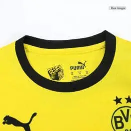 a yellow shirt with black trim