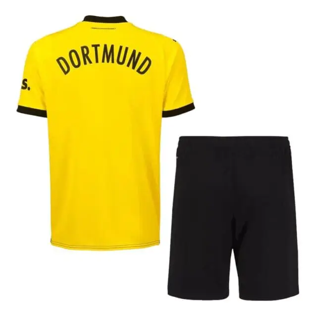 a yellow shirt and black shorts