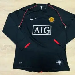 a black sports jersey on a wooden surface