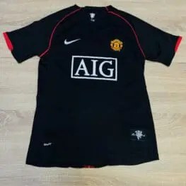 a black sports jersey with a red stripe on it