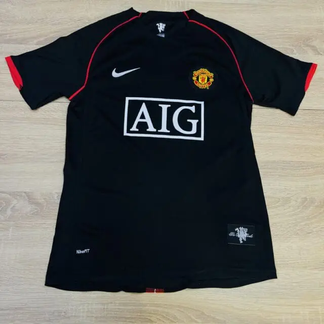 a black sports jersey with a red stripe on it