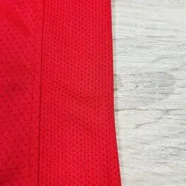 a red fabric with a mesh on it