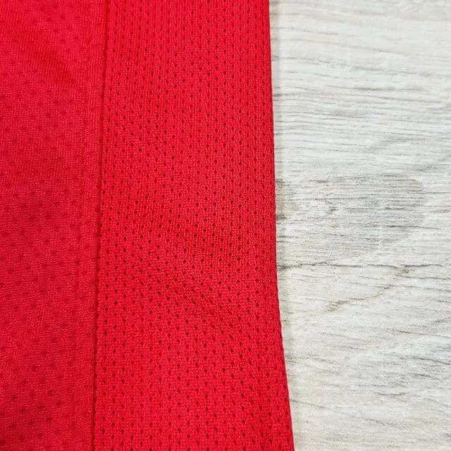 a red fabric with a mesh on it