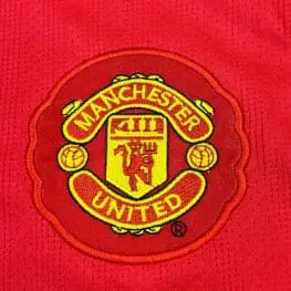 a red and yellow logo on a red shirt