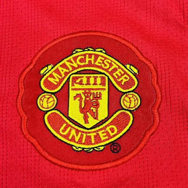 a red and yellow logo on a red shirt