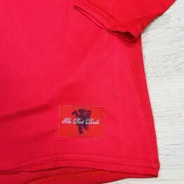 a red shirt with a logo on it