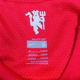 a red shirt with white text and a logo