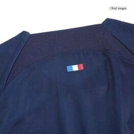 a blue shirt with a small flag on it