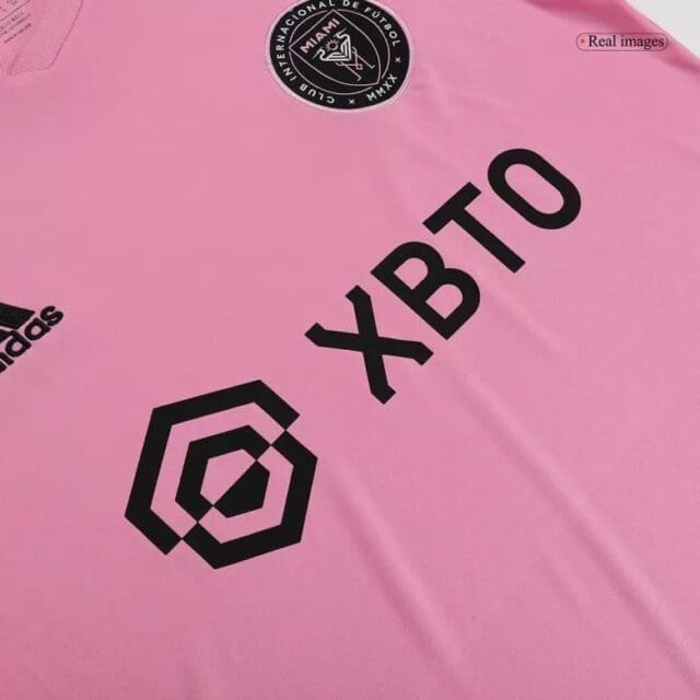 a pink shirt with black text