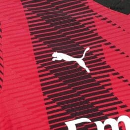 a close up of a red and black sports jersey