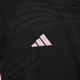 a black shirt with a pink logo