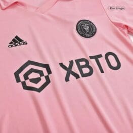 a pink shirt with black text