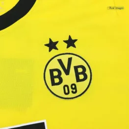 a yellow jersey with black text and stars