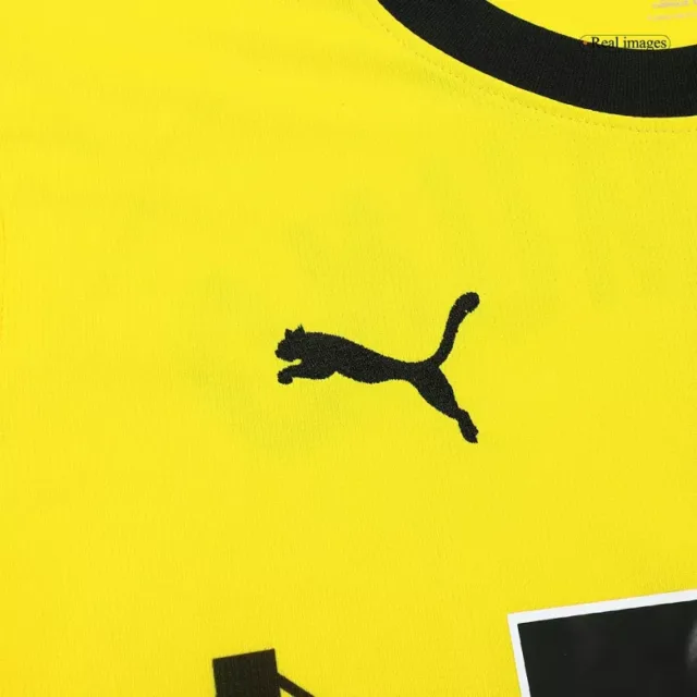 a yellow shirt with a black logo