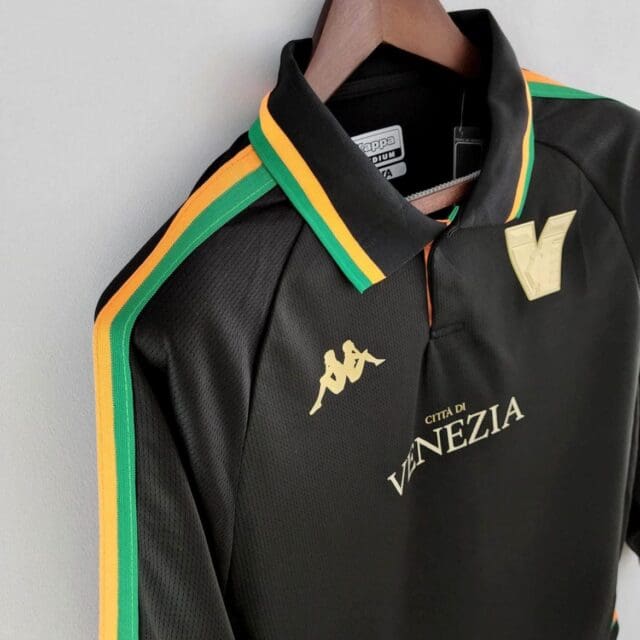 a black shirt with yellow and green stripes on a swinger