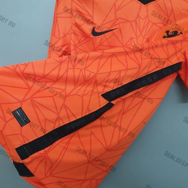 an orange sports shorts with black stripes