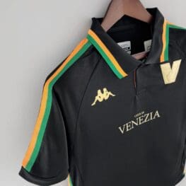 a black shirt with yellow and green stripes on a swinger
