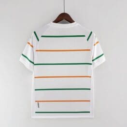 a white shirt with orange and green stripes on a swinger