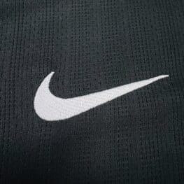 a white swoosh on a black fabric