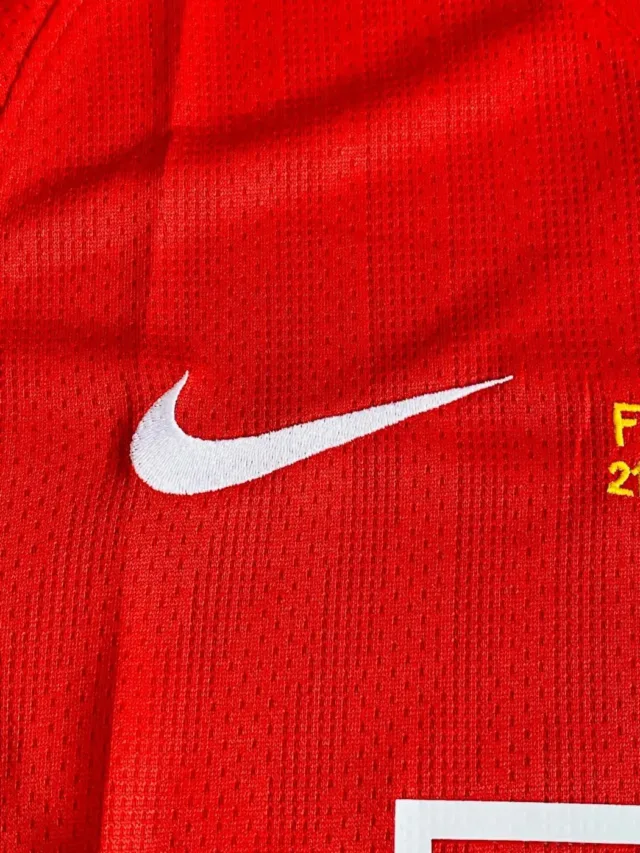 a red jersey with a white swoosh